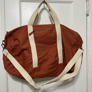 Known supply Terra cotta duffle bag